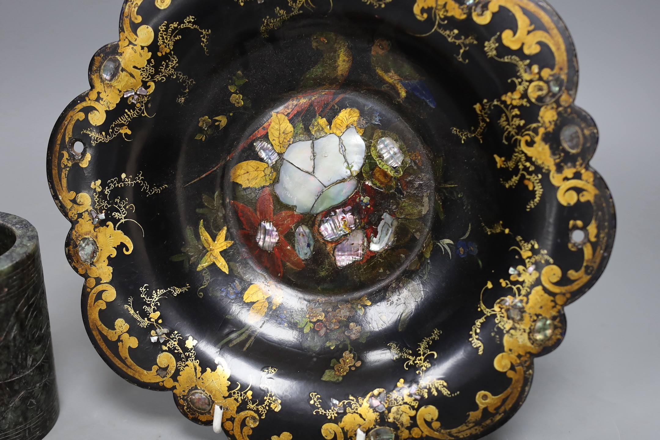 A Chinese soapstone brush pot and a group of netsuke and a papier mache dish, 26cms diameter